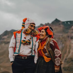 Man and Woman in Traditional Clothing Looking at Each Other and Smiling